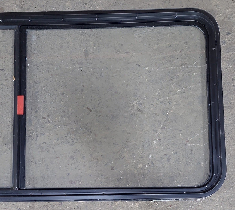 Used Black Radius Emergency Opening Window : 55 1/2" W x 25 1/2" H x 1 7/8" D - Young Farts RV Parts