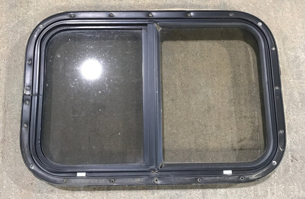 Used Black Radius Opening Window : 24 1/2" W x 19 1/4" H x 1 1/4" - Young Farts RV Parts