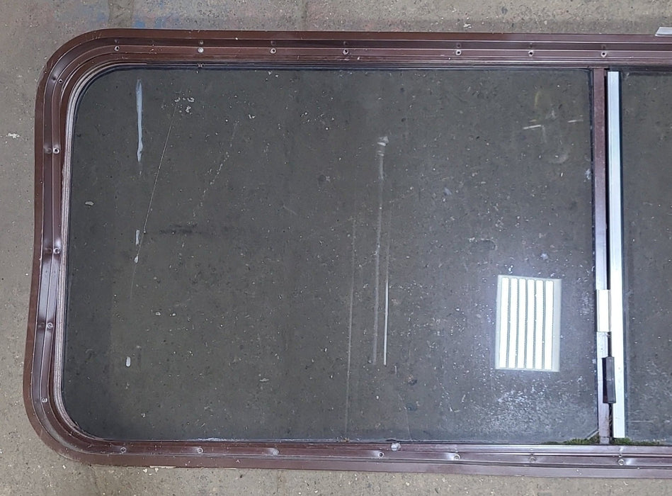 Used Slanted Brown Radius Opening Window : 22 1/8" H X 58 3/4" W  X 2" D